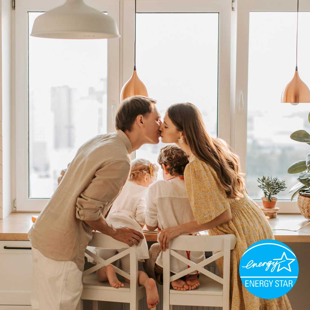 Family in Emerald Coast looking out a picture window. Family enjoying Window Depot windows.